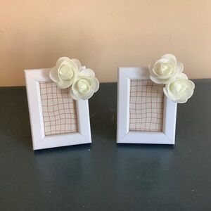 Set of 2…2x3 white frames embellished with two milky white rosebuds